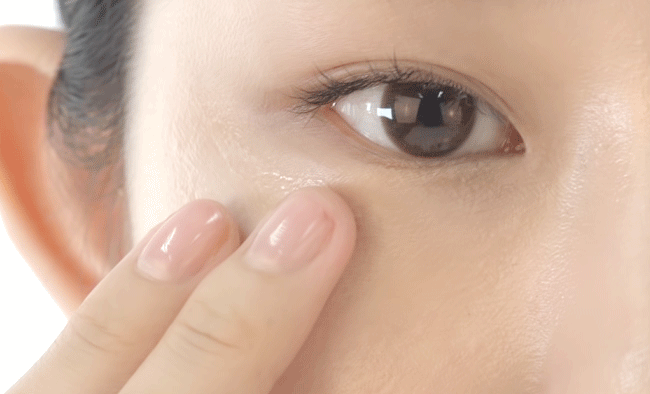 Applying eye cream on the eye area